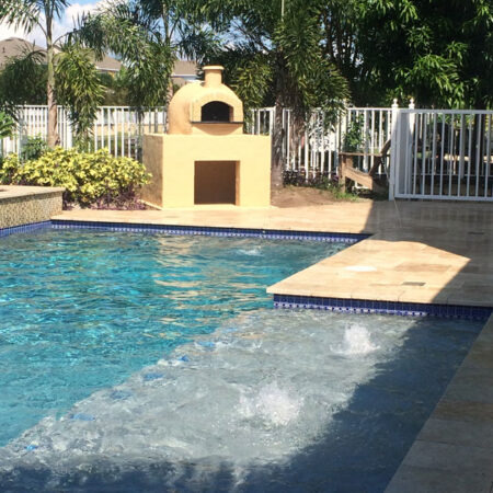 A Forno Nardona wood fired pizza oven situated by a pool in Tampa, FL.
