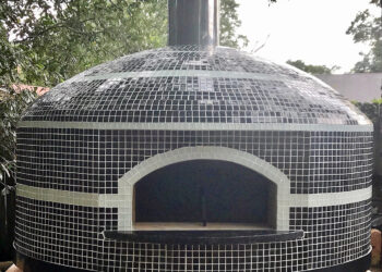 Forno Nardona Napoli wood fired oven with Willow Brook glass tile on a custom travertine base.