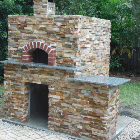 Freestanding Firence with side bar with real flagstone exterior and red brick opening.
