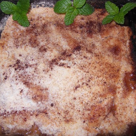 Apple Crumble garnished with mint cooked in a Pyrex dish in a Forno Nardona wood-fired oven.