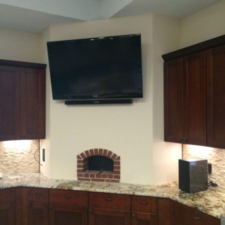 Forno Nardona Indoor Pizza Oven installed inside a kitchen with a TV mounted above it.