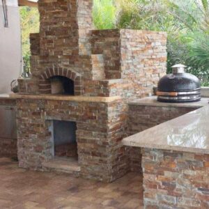 Stone-clad outdoor pizza oven with polished counter