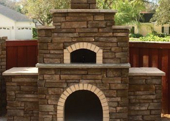 Large multi-tiered Forno Nardona Firenze outdoor brick oven with stone finish.