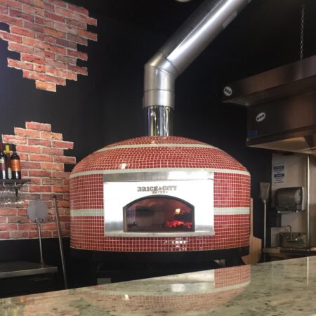 Commercial pizza oven by Forno Nardona in red and white tiles located at the Brick City Eatery in Lutz, Florida.