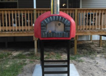 Outdoor pizza oven with red exterior in the Rustico Model