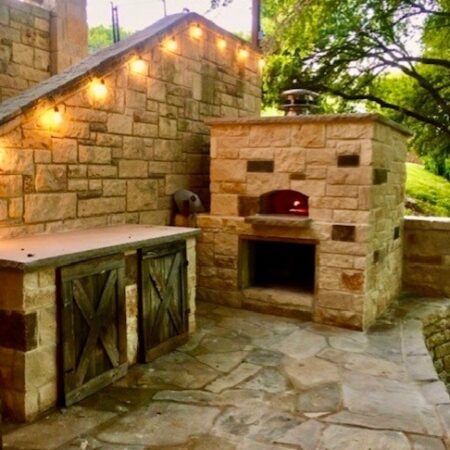 A large, stone outdoor pizza oven