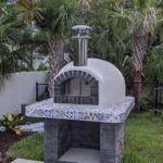 Forno Nardona Rustico Oven with black firebrick face and white stucco dome installed on a customer built base.