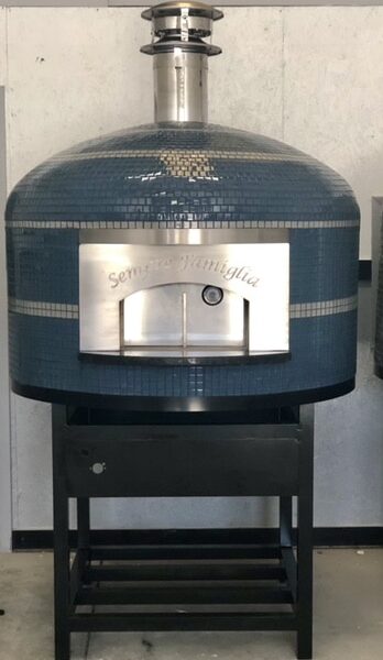 Blue tiled Napoli Oven by Forno Nardona with gray striping and black grout positioned on a Forno Nardona black powder coated stand with gas burner installed.