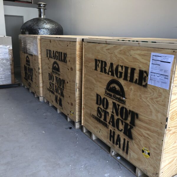 Three Forno Nardona ovens packed in crates and ready for shipping.