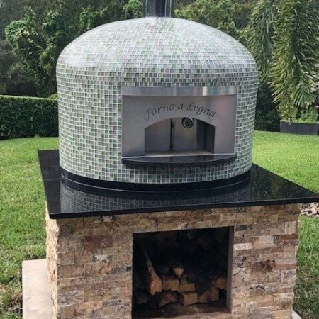 Forno Nardona Napoli wood fired pizza oven with Willow Brook glass tile on a custom travertine base.
