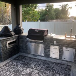 Stylish and sleek L-shaped Tampa built outdoor kitchen by Forno Nardona with Lion Premium BBQ products.