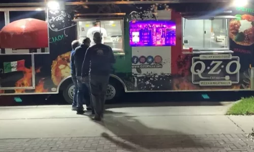 Sideview of a pizza food truck with at 48" Commercial Nardona Rustico oven to the left.