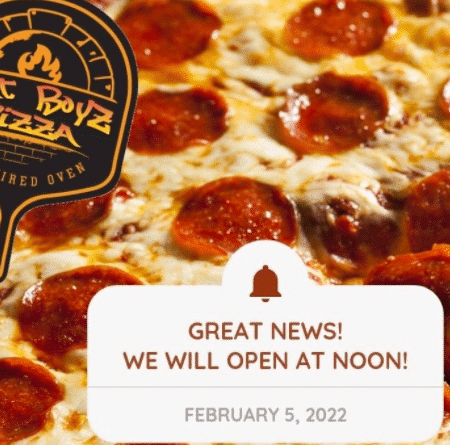 Up close photo of a pepperoni pizza with a Fat Boyz Pizza logo.