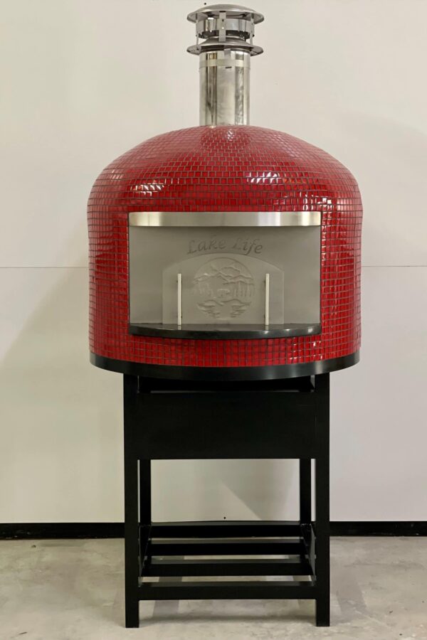 24" Forno Nardona Napoli residential oven on a black powder coated stand and finished in red glass tile with a personalized face plate which says "Lake Life" and an external door with a bear on a lake motif.
