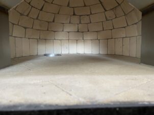 Interior view of Nardona dome with gas ring Nardona Napoli oven interior showing real fire brick dome and real fire brick cooking floor with a gas ring to the back left.
