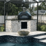 Forno Nardona Rustico 32" in black tile and black brick front on a Forno Nardona built base in stone and black granite poolside.