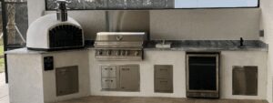 White stucco outdoor kitchen with dome oven