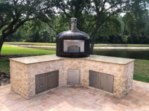 Nardona Napoli 32" in Glass Copper Tile on large custom base of granite and stone with ample storage with a beautiful open lake area behind it.