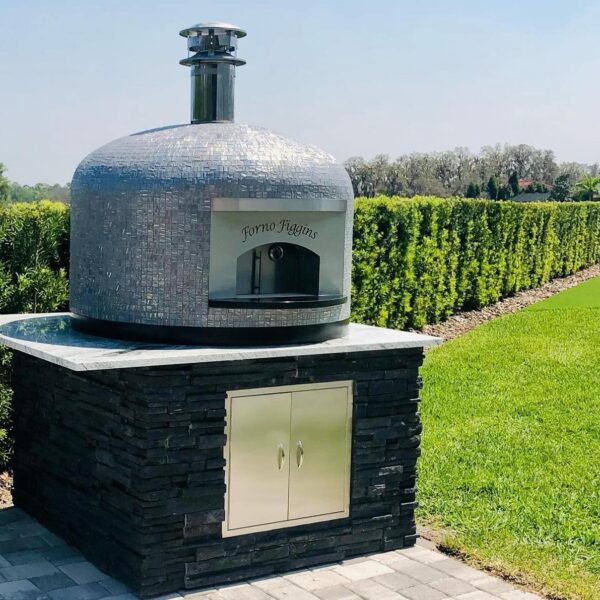 32" Nardona Napoli oven in moon tile set on a white granite surface on top of a custom base with black stone and stainless wood storage door.