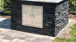 Forno Nardona pizza oven base finished in black stone with a stainless double door by Lion Premium.