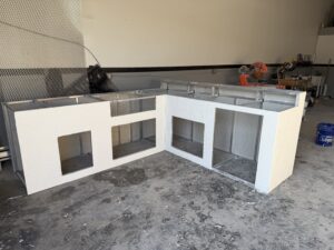 Outdoor kitchen framing in two pieces connected at the corner to form an L shape.