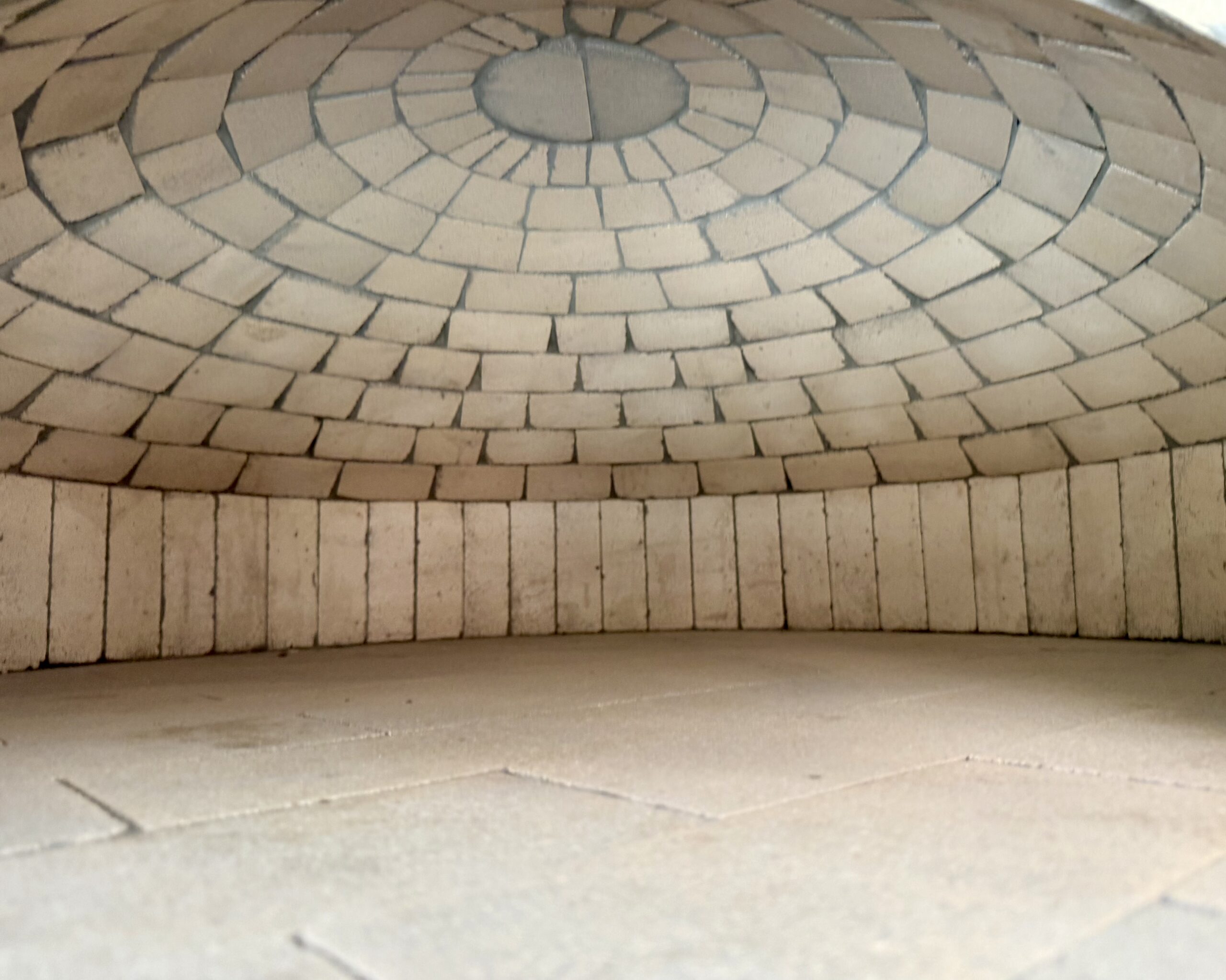 Restaurant Pizza Ovens That Earn Their Keep have a solid thermal mass like this domed pizza oven by Forno Nardona